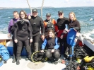 Harry Dort, Stephanie HilIison, Terry Dwyer Andy Olsson, Suzie Dwyer (kneeling) Robert Guertin and Ally Wynn in between dives on the Costa Rican Trader in Halifax Harbour.